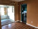 Dining room with wood floors, sliding glass doors, and view of the kitchen at 636 S Wellington Dr, Deltona, FL 32725