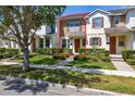 Inviting townhome featuring manicured landscaping and a covered front entry for a welcoming appeal at 7010 Broomshedge Trl, Winter Garden, FL 34787