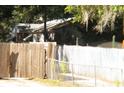 Property backyard framed by a wooden fence and mature trees, creating a sense of privacy and seclusion at 7506 Mott Ave, Orlando, FL 32810