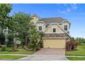 Charming two-story home featuring stone accents, a two-car garage, and a beautifully landscaped front yard at 850 Spring Oak Cir, Orlando, FL 32828