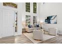 Bright living room with high ceilings, a large window, and stylish decor, creating an inviting and elegant space at 850 Spring Oak Cir, Orlando, FL 32828