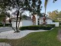 A single-story home with beautiful landscaping, featuring a paved driveway and a well-maintained lawn at 9959 Cypress Vine Dr, Orlando, FL 32827