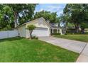 Well-maintained single-story home featuring an attached two-car garage and lush green lawn at 1018 Featherstone Cir, Ocoee, FL 34761
