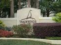Tradewinds community sign surrounded by mature landscaping and colorful foliage at 1071 S Hiawassee Rd # 1211, Orlando, FL 32835