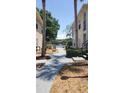 Scenic community path leading to lake views with lush greenery and well-kept landscaping at 1071 S Hiawassee Rd # 1211, Orlando, FL 32835