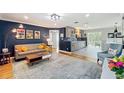 Open-concept living area with modern decor, gray sofa, and seamless flow into the kitchen at 1202 Chichester St, Orlando, FL 32803