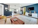 Bright living room with hardwood floors, modern decor, and an open view into the kitchen at 1202 Chichester St, Orlando, FL 32803