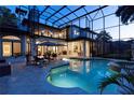 Beautiful private pool with screened enclosure, poolside seating, and manicured landscaping at 1716 Greystone Ct, Longwood, FL 32779