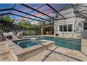 Beautiful screened-in pool with spa and ample seating area, perfect for relaxing and entertaining at 1909 Donahue Dr, Ocoee, FL 34761