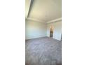 Spacious carpeted bedroom with tray ceiling and ensuite bathroom at 1912 Diamond Head Cir, Lake Hamilton, FL 33851