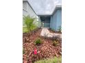 Charming front yard with lush, drought-tolerant landscaping and a welcoming entrance at 1912 Diamond Head Cir, Lake Hamilton, FL 33851