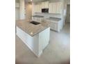 Bright kitchen with white cabinets, granite countertops, and stainless steel appliances at 1912 Diamond Head Cir, Lake Hamilton, FL 33851