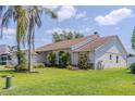 View of the side of the home, showcasing its architectural style, landscaping, and well-maintained lawn at 1949 Tiptree Cir, Orlando, FL 32837