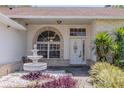Close-up view of the front door, detailed window, and water feature enhancing curb appeal at 1949 Tiptree Cir, Orlando, FL 32837