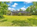 Spacious backyard featuring lush greenery and a screened-in pool area for outdoor enjoyment at 2108 Silver Leaf Ct, Longwood, FL 32779
