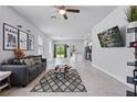 Spacious living room with tile flooring, modern decor, and an open layout with a ceiling fan at 2618 Sidney Ave, Orlando, FL 32810