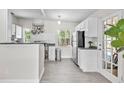Bright kitchen with stainless steel appliances, tile floors, and a rack with hanging pots at 2707 E Marks St, Orlando, FL 32803