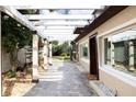 Charming backyard with a pergola-covered patio and a well-maintained walkway at 2711 Parkland Dr, Winter Park, FL 32789