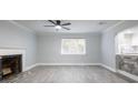 Spacious living room featuring a fireplace, ceiling fan, and large window for ample natural light at 2711 Parkland Dr, Winter Park, FL 32789