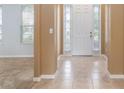 Inviting foyer with tile flooring, neutral walls, and a view into the adjacent living area at 2780 Running Springs Loop, Oviedo, FL 32765