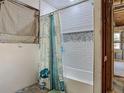 Bathroom featuring white subway tile and a mosaic tile accent in the shower at 288 N Seneca St, Daytona Beach, FL 32114