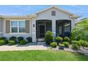 Inviting front porch with screen door, landscaping, and exterior architectural features at 2952 Boating Blvd, Kissimmee, FL 34746