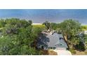 High-angle shot of a home near a waterfront featuring a pool and surrounded by lush greenery and trees at 3385 Lake Harney Cir, Geneva, FL 32732