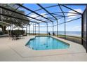 Relaxing screened pool area featuring tranquil views of the water and comfortable seating at 3385 Lake Harney Cir, Geneva, FL 32732