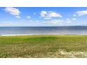 Expansive view of the adjacent body of water with blue skies and cloudscape above at 3385 Lake Harney Cir, Geneva, FL 32732