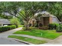 Brick house with mature tree in the front yard at 343 Raleigh Pl, Oviedo, FL 32765