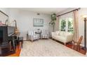 Elegant living room with a piano, stylish seating, and a view of the outdoors at 343 Raleigh Pl, Oviedo, FL 32765
