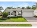 Attractive single-story home featuring a two-car garage, green lawn, and lush landscaping at 3456 Michigan St, Lake Mary, FL 32746