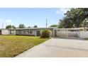 Well-maintained single-story home boasting a carport, green lawn, and refreshed exterior at 4604 S Shore Rd, Orlando, FL 32839