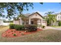 Single-story home with landscaped front yard and two-car garage in a suburban neighborhood at 5126 Rishley Run Way, Mount Dora, FL 32757
