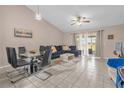 Bright and inviting living area with vaulted ceilings and sliding glass doors to the patio at 543 Azinger Cir, Orlando, FL 32824