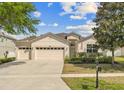 Inviting single-story home with a spacious driveway, large garage, and well-maintained landscaping at 5839 Tarleton Way, Mount Dora, FL 32757