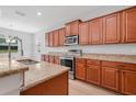 Modern kitchen features stainless steel appliances, granite countertops, and wood cabinetry at 5839 Tarleton Way, Mount Dora, FL 32757