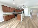 Spacious kitchen featuring stainless steel appliances, granite countertops, and a kitchen island at 5839 Tarleton Way, Mount Dora, FL 32757