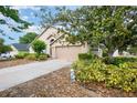 Charming single-Gathering home featuring a two-car garage and landscaped front yard at 6019 Long Peak Dr, Orlando, FL 32810