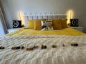 Beautiful bedroom features bright yellow bedding, decorative pillows, and comfortable stylish accents at 6403 Parc Corniche Dr # 4308, Orlando, FL 32821