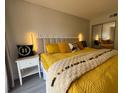 Inviting bedroom featuring a plush, yellow-themed bed, decorative pillows, and a cozy atmosphere at 6403 Parc Corniche Dr # 4308, Orlando, FL 32821