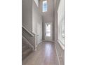 Inviting foyer with wood-look tile, and a front door featuring glass panes that let in lots of natural light at 6728 Great Bear Dr, Lakeland, FL 33805