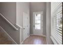 Inviting foyer with wood-look tile, and a front door featuring glass panes that let in lots of natural light at 6728 Great Bear Dr, Lakeland, FL 33805