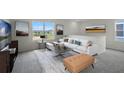 Cozy upstairs living room features a white sofa, neutral decor, and ample natural light at 699 Griffon Ave, Lake Alfred, FL 33850