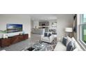 Open-concept floor plan showcases the living room, kitchen, and dining area in a seamless design at 699 Griffon Ave, Lake Alfred, FL 33850