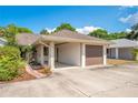 Charming home featuring an attached garage, carport, inviting front yard, and appealing curb appeal at 720 Lakeside Dr, Winter Springs, FL 32708