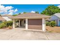 Charming home featuring an attached garage, carport, and inviting front yard landscaping at 720 Lakeside Dr, Winter Springs, FL 32708