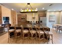 A spacious kitchen featuring a large island with seating, pendant lighting and stainless steel appliances at 7458 Brooklyn Dr, Kissimmee, FL 34747