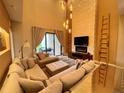 Inviting living room with comfortable seating, a stone accent wall, and sliding glass doors to the patio at 7458 Brooklyn Dr, Kissimmee, FL 34747