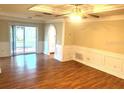 Spacious room showcasing hardwood floors, recessed lighting, with sliding door access to the patio at 7540 Govern Blvd, Orlando, FL 32822
